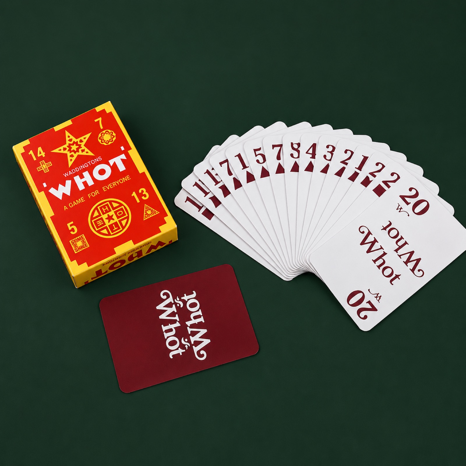 Real Whot card box, card back, and fan of Whot cards on a green table.